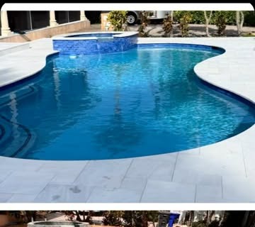 Pool deck after renovation, new paver deck and clean pool