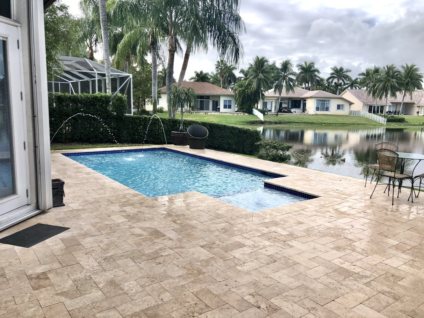 Natural stone paver pool deck on lakefront property