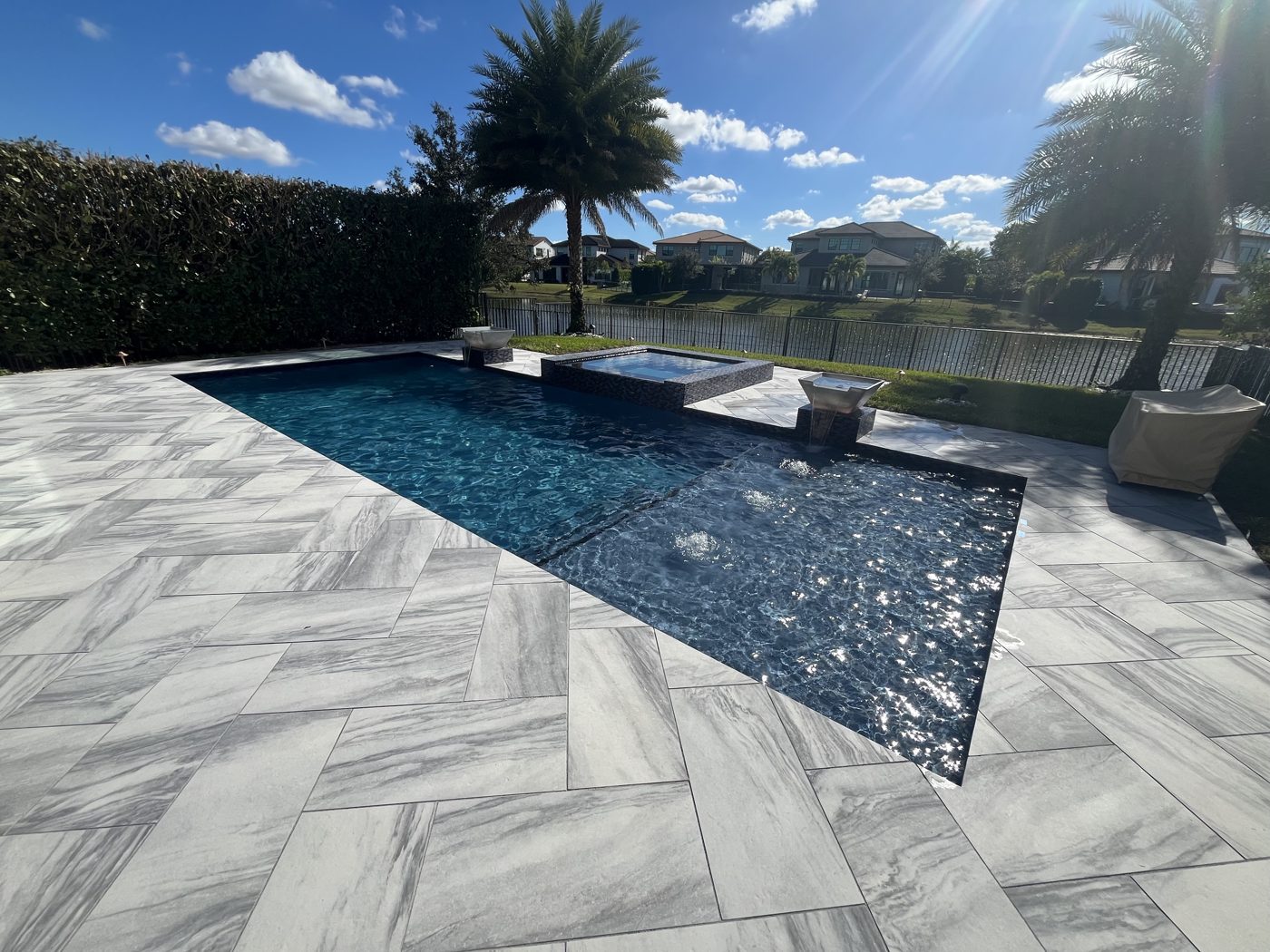 Porcelain paver pool deck around lakefront pool and spa