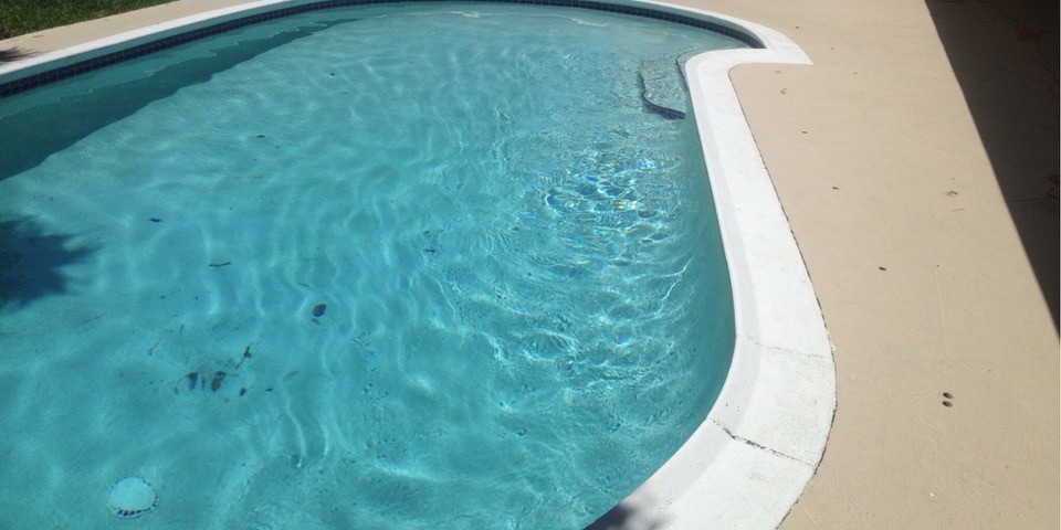 Pool deck before resurfacing, plain concrete