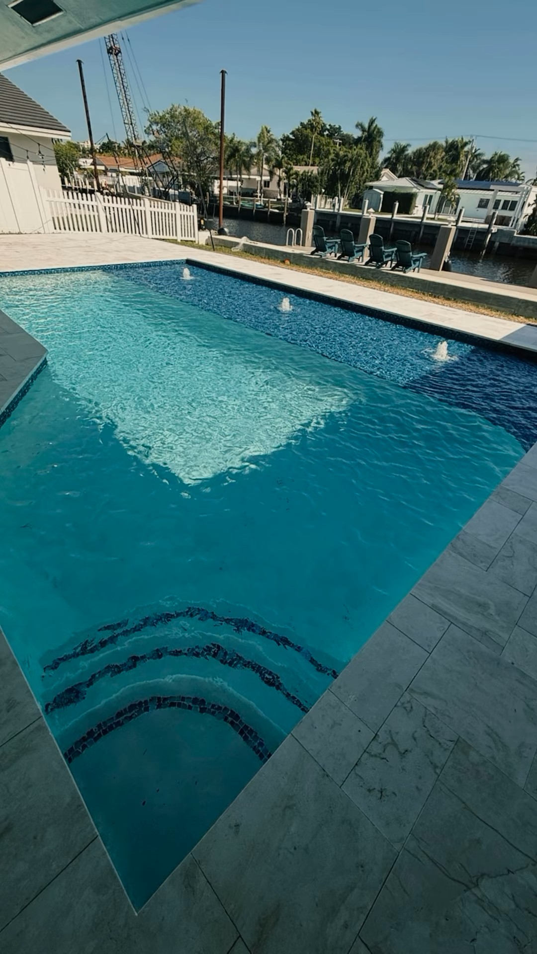 Canal-front luxury pool with deck jets in Delray Beach, FL