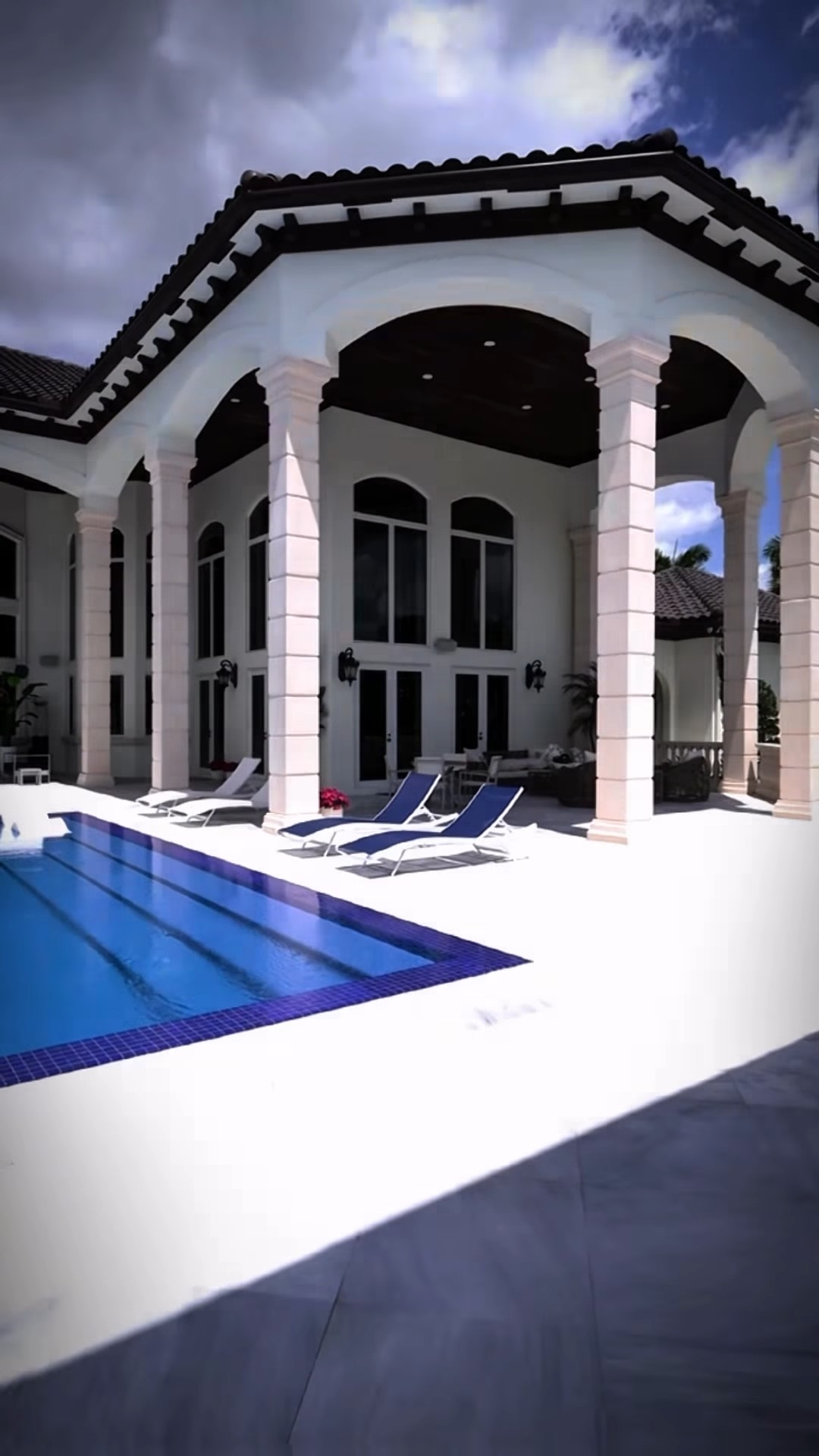 Mediterranean-style estate pool with covered loggia in Parkland, FL