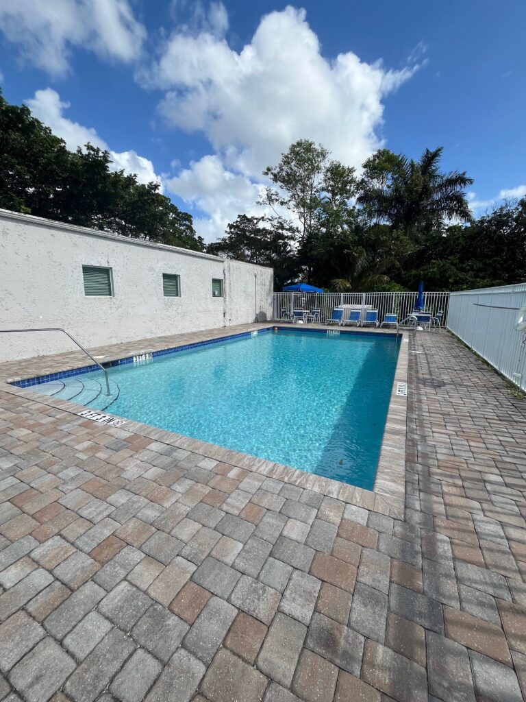 New commercial pool construction with paver deck in Davie