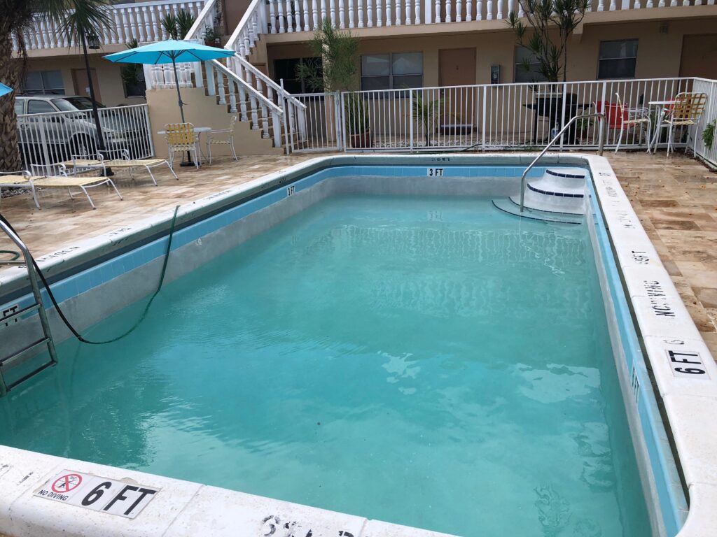 Resurfaced commercial pool with new waterline tile at a Fort Lauderdale multi-family property