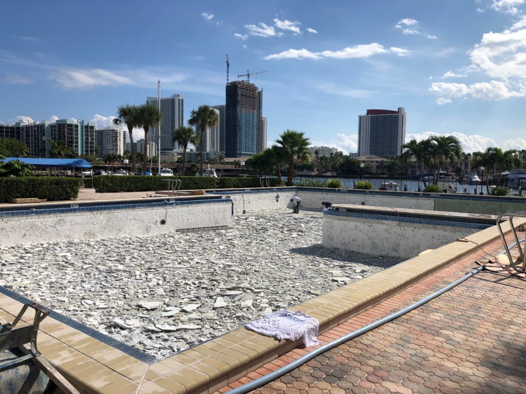 Commercial pool interior finish removal during resurfacing at a Hallandale condominium property